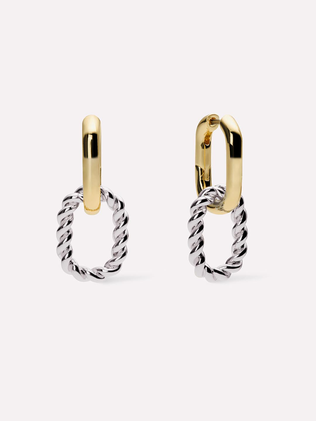 Pair of gold and silver hoop earrings on a light gray background