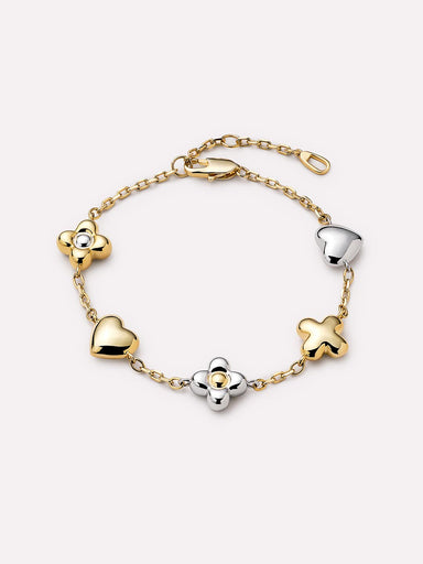 Gold and silver bracelet with heart and clover-shaped charms on a white background