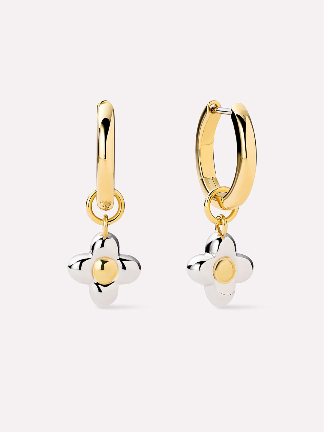 Gold and silver flower-shaped earrings on a white background