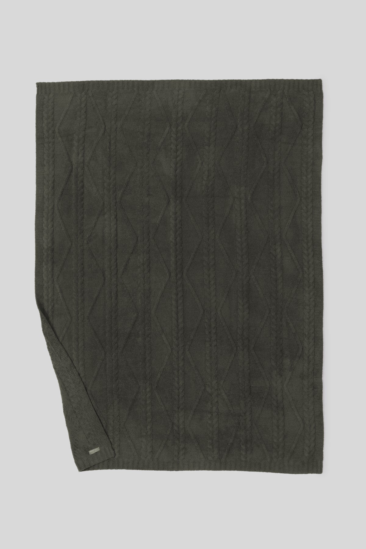 Dark green quilted fabric on a light gray background