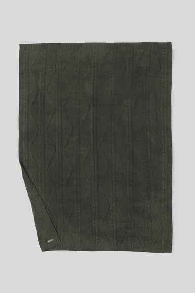 Dark green quilted fabric on a light gray background