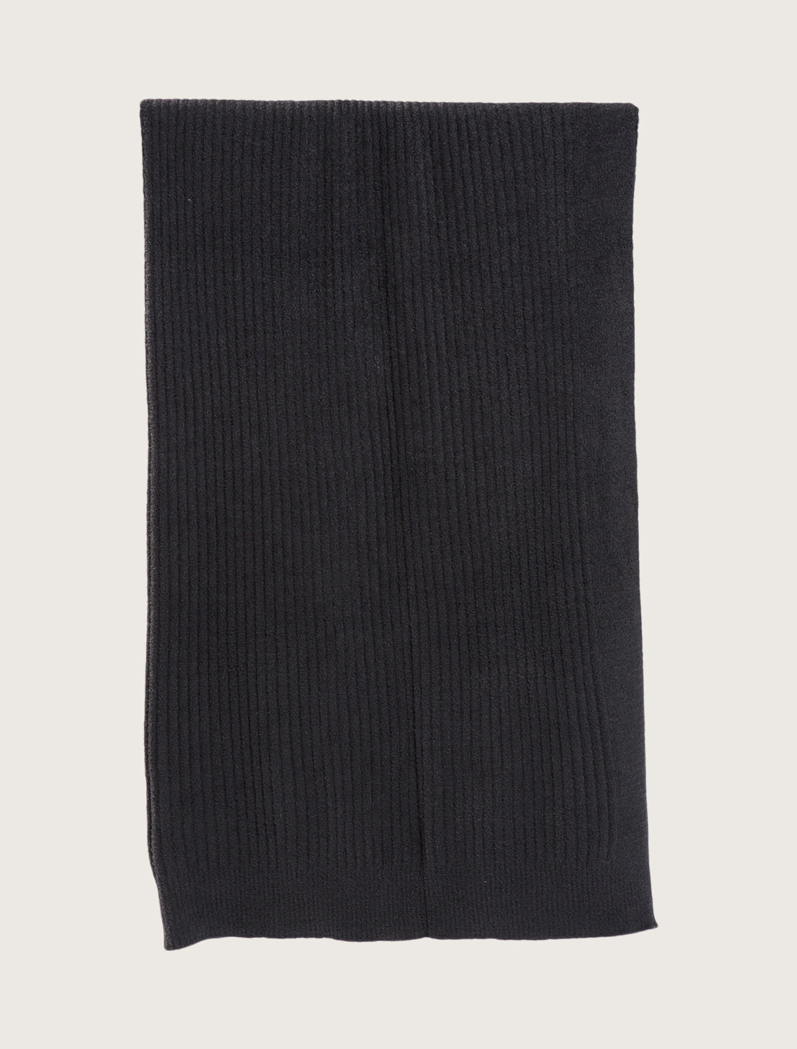 Black ribbed knit blanket on a light gray background