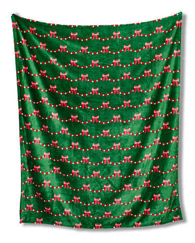 Green fabric with red bow and string pattern on a white background