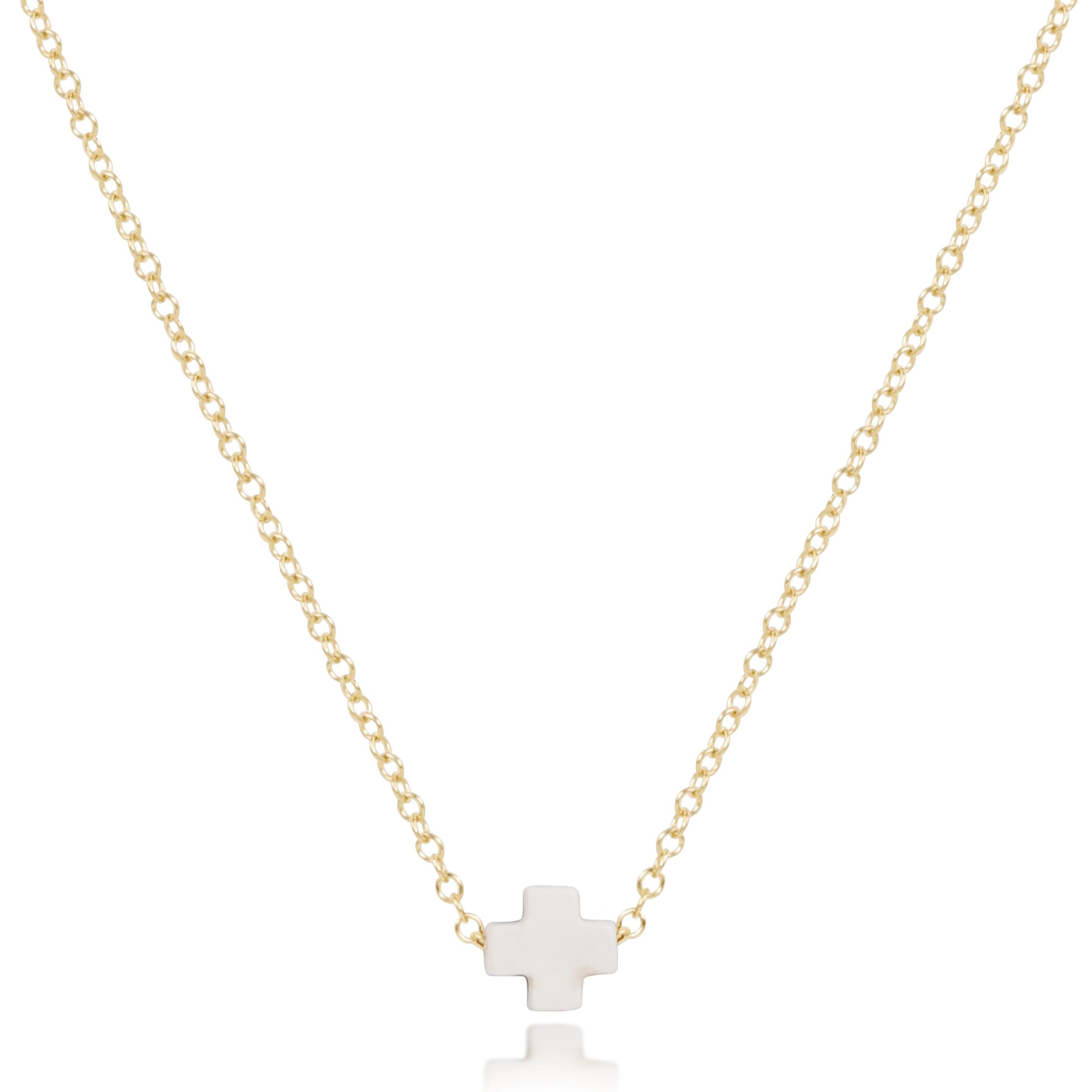 A gold-filled 16-inch chain necklace with an off-white small signature cross pendant from ENewton.