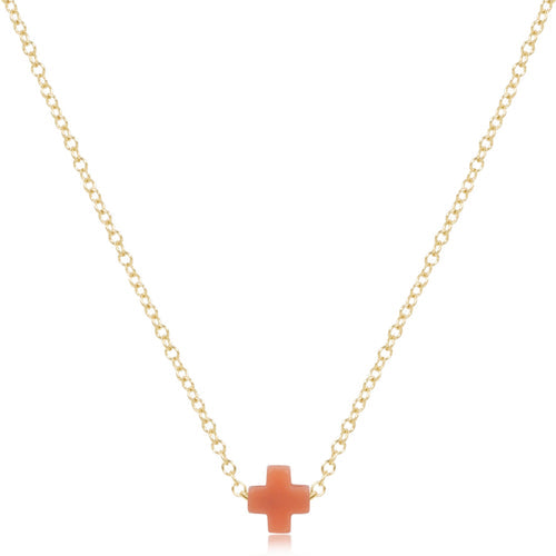 Gold necklace with a small cross pendant on a white background
