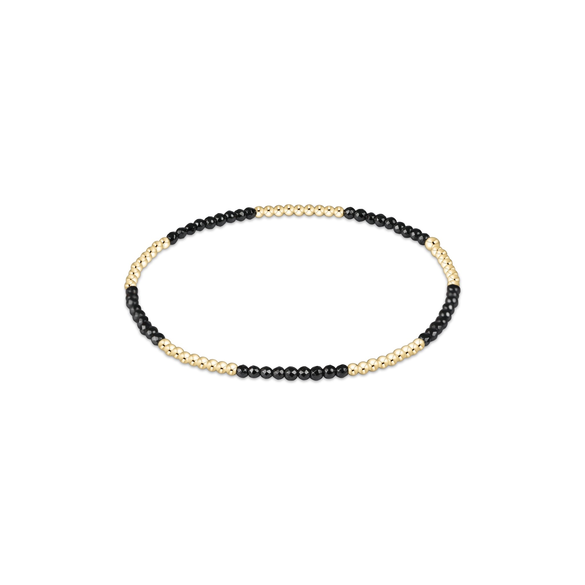 Bracelet with black beads and gold accents on a white background