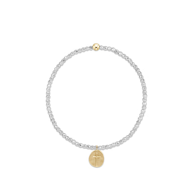 Bracelet with gold and silver charms on a white background