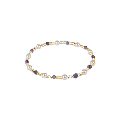 Bracelet with pearls and gold accents on a white background