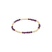 Bracelet with purple beads and gold accents on a white background