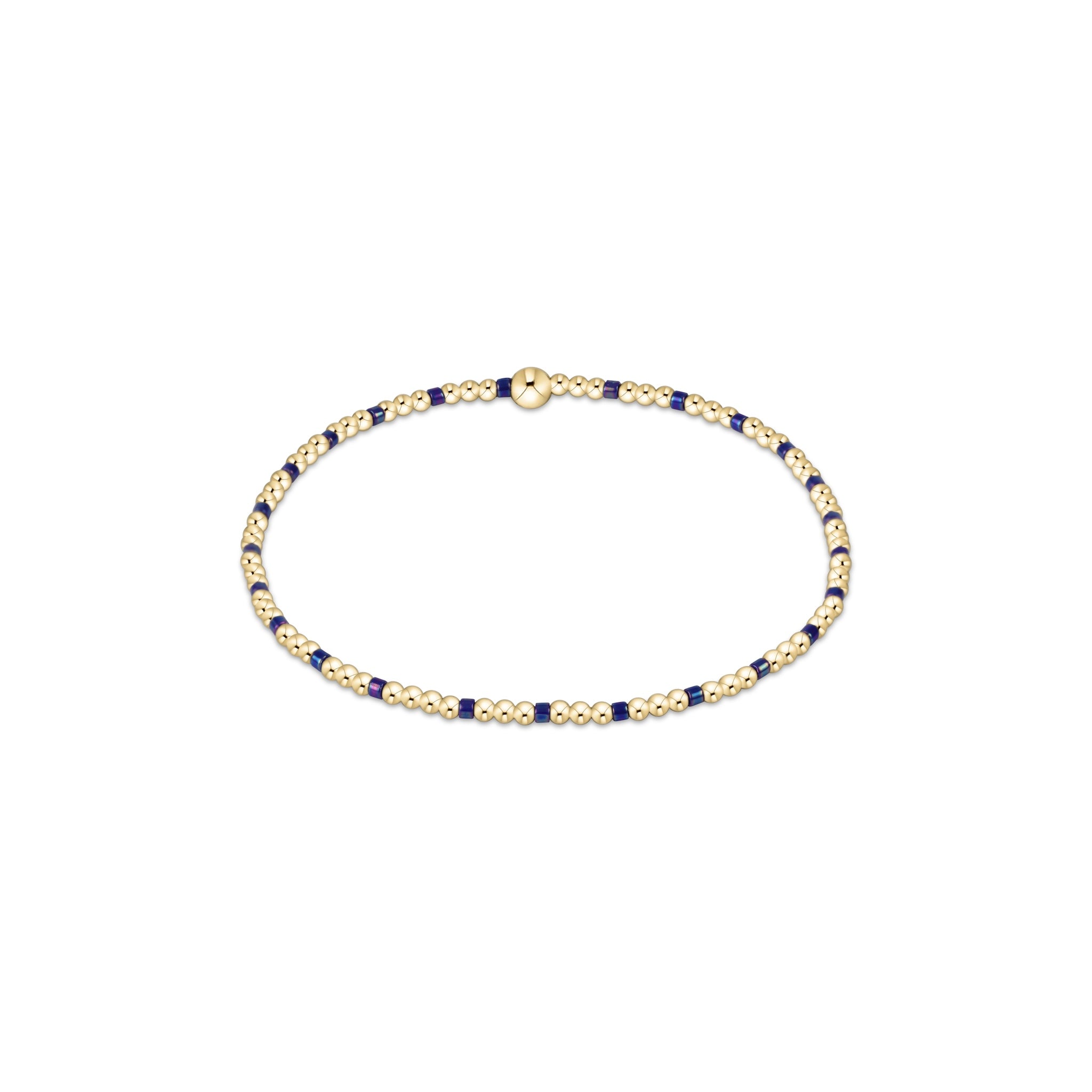 Gold and blue beaded bracelet on a white background