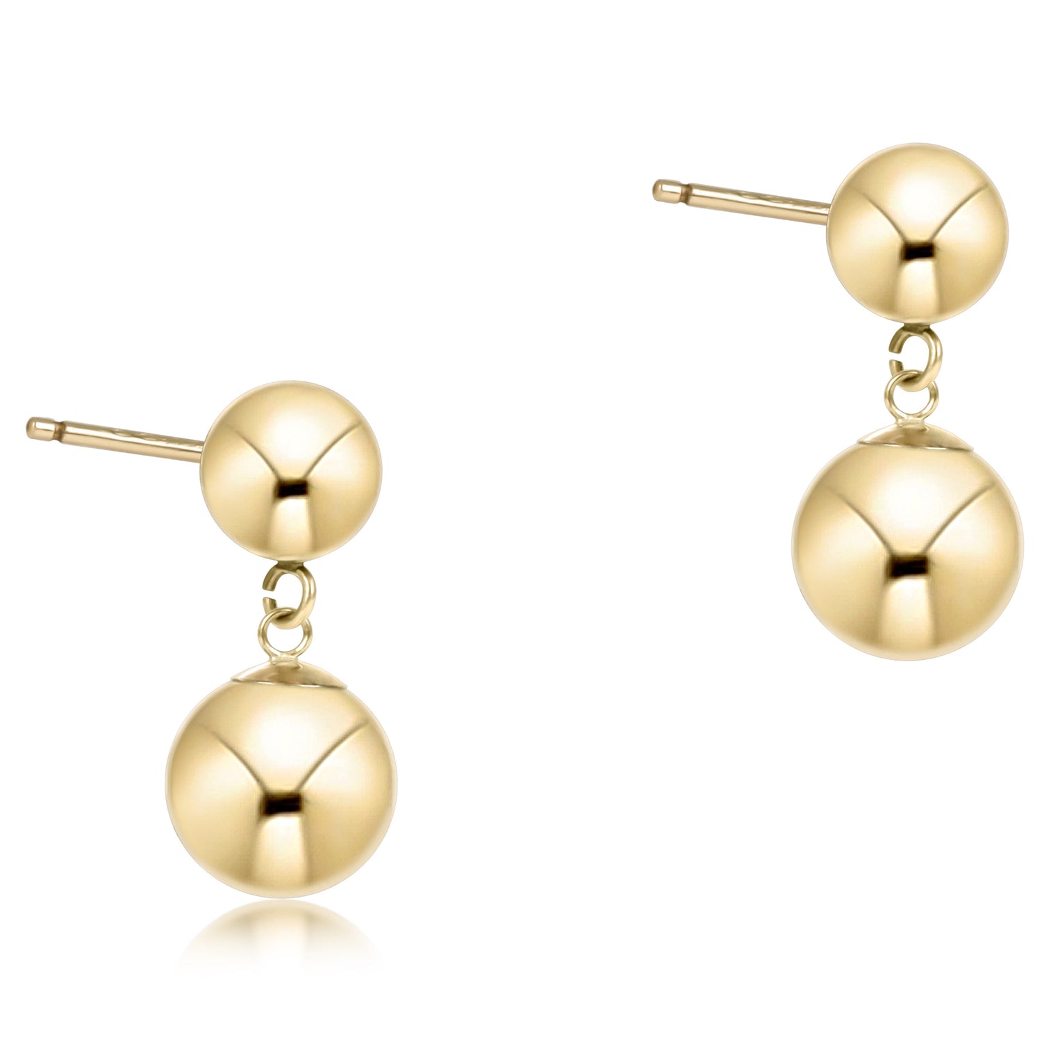 Pair of gold ball earrings on a white background