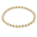 Gold beaded necklace on a white background