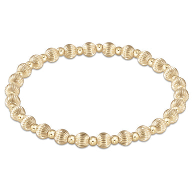 Gold beaded bracelet on a white background