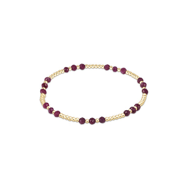 Bracelet with gold and purple beads on a white background