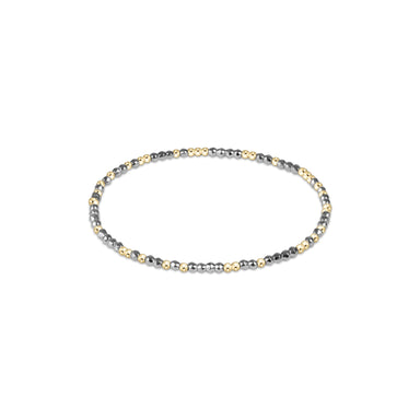 Beaded bracelet with three different metal finishes on a white background