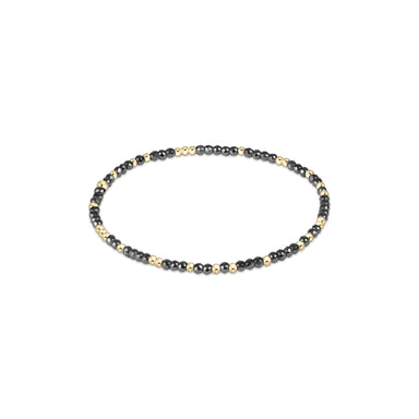 Beaded bracelet with black and gold beads on a white background