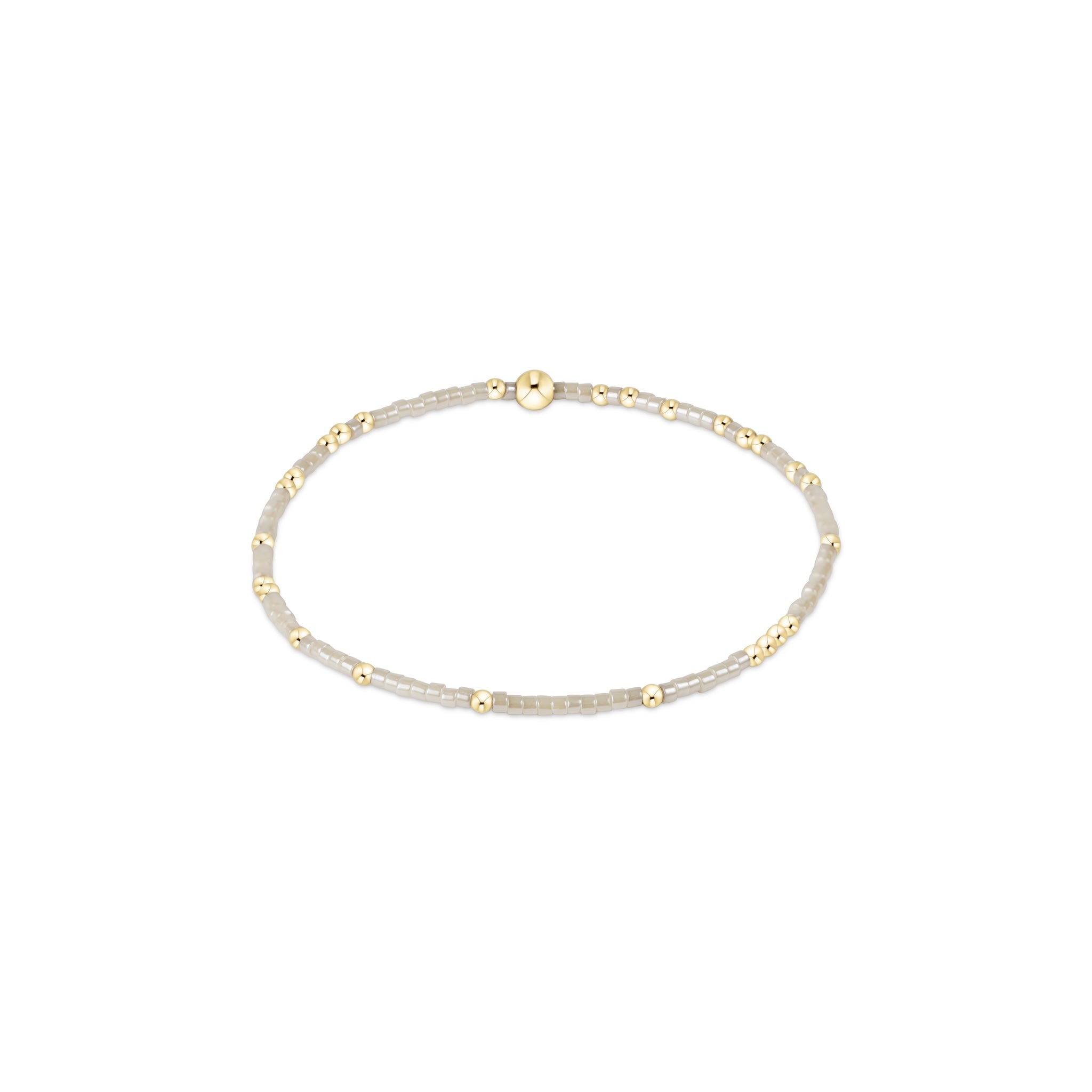 Gold and silver beaded bracelet on a white background