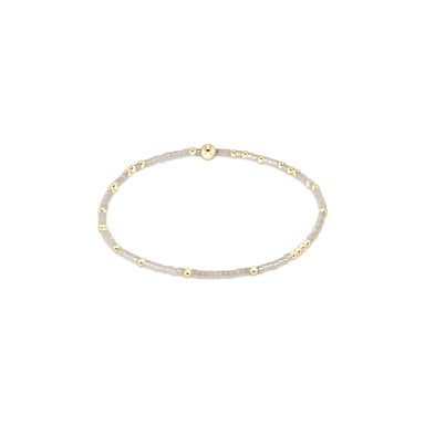 Gold and silver beaded bracelet on a white background