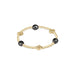 Gold bracelet with black beads on a white background