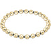 Gold beaded bracelet on a white background