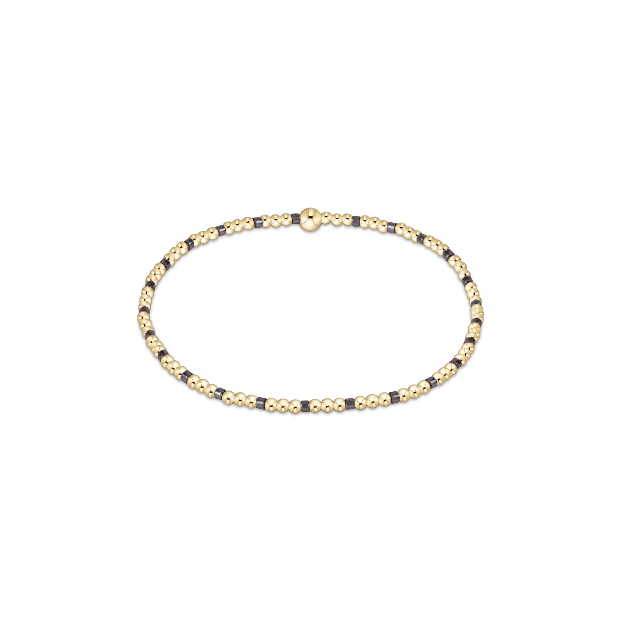 Gold and black beaded necklace on a white background