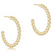 Gold hoop earrings with bead detailing on a white background