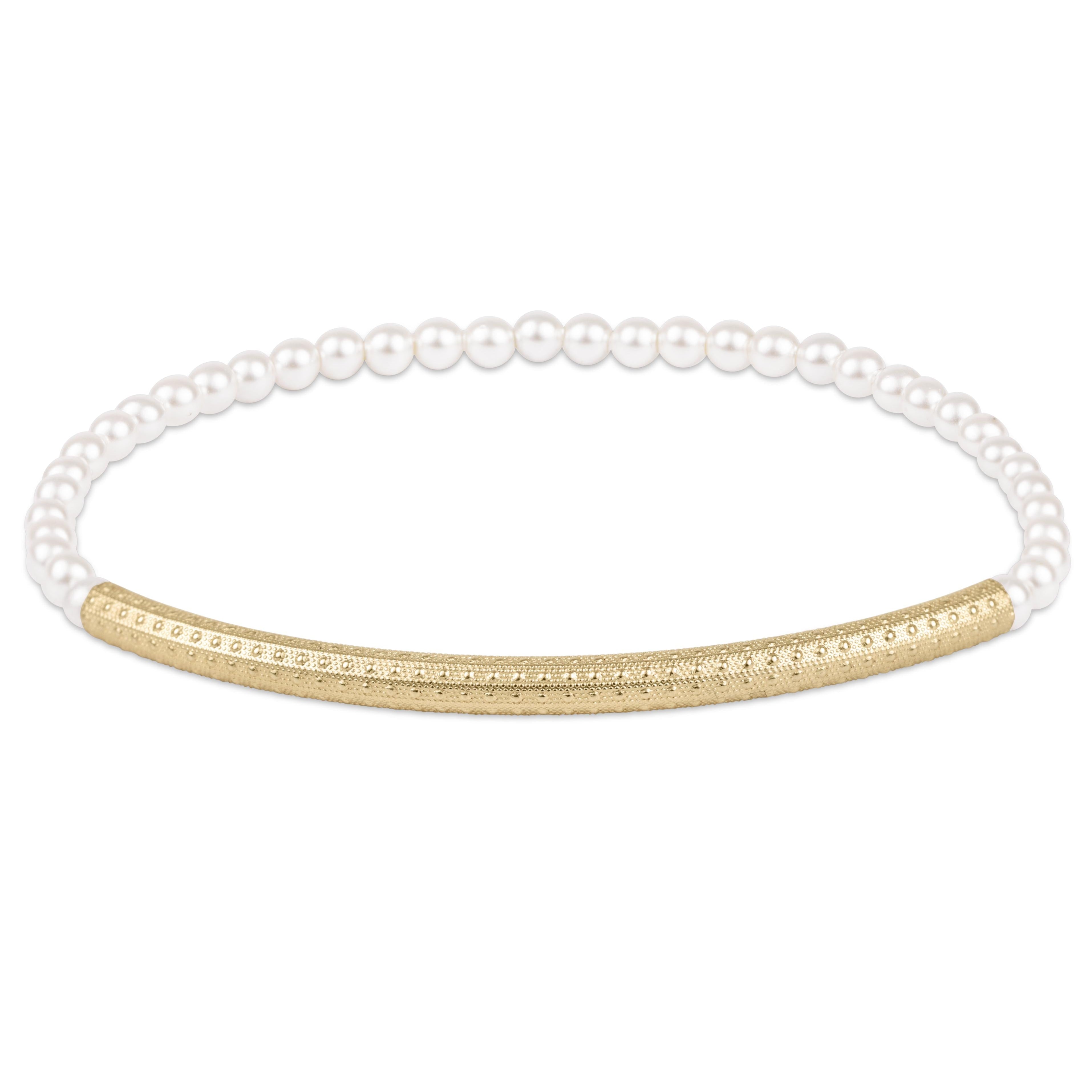 Pearl bracelet with a gold accent on a white background