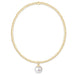 Gold necklace with a single pearl pendant on a white background
