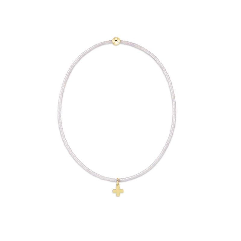 White cord necklace with gold pendants on a white background
