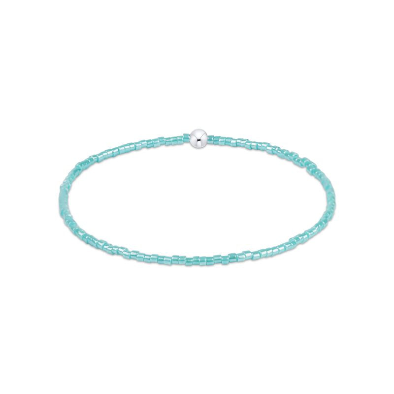 Turquoise beaded choker necklace with a silver clasp on a white background