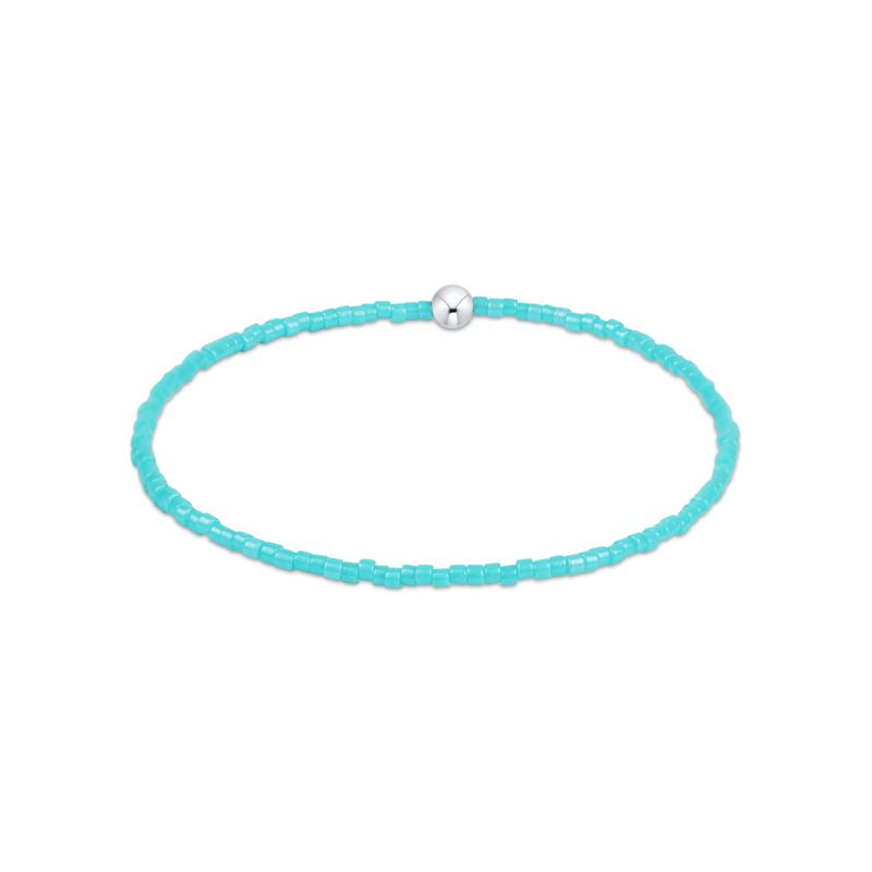 Turquoise beaded bracelet with a silver clasp on a white background