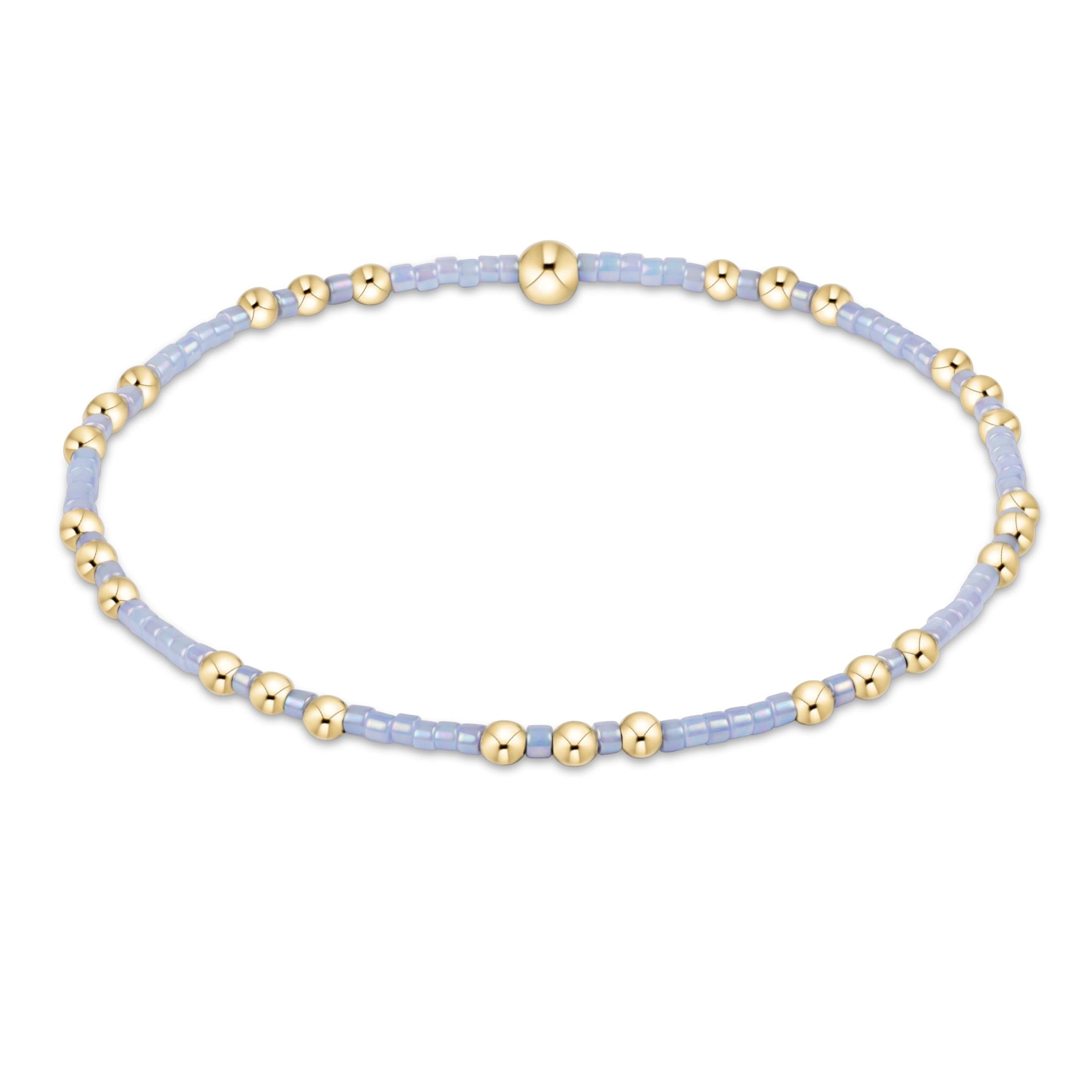 Bracelet with gold and light blue beads on a white background