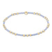 Bracelet with gold and light blue beads on a white background