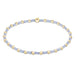 Bracelet with gold and light blue beads on a white background