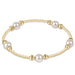 Gold and pearl bracelet on a white background