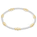 Bracelet with alternating gold and silver beads on a white background