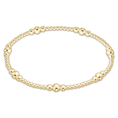 Gold beaded bracelet on a white background