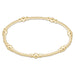 Gold beaded bracelet on a white background