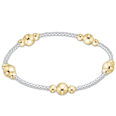Gold and silver beaded bracelet on a white background