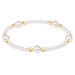Pearl bracelet with gold beads on a white background