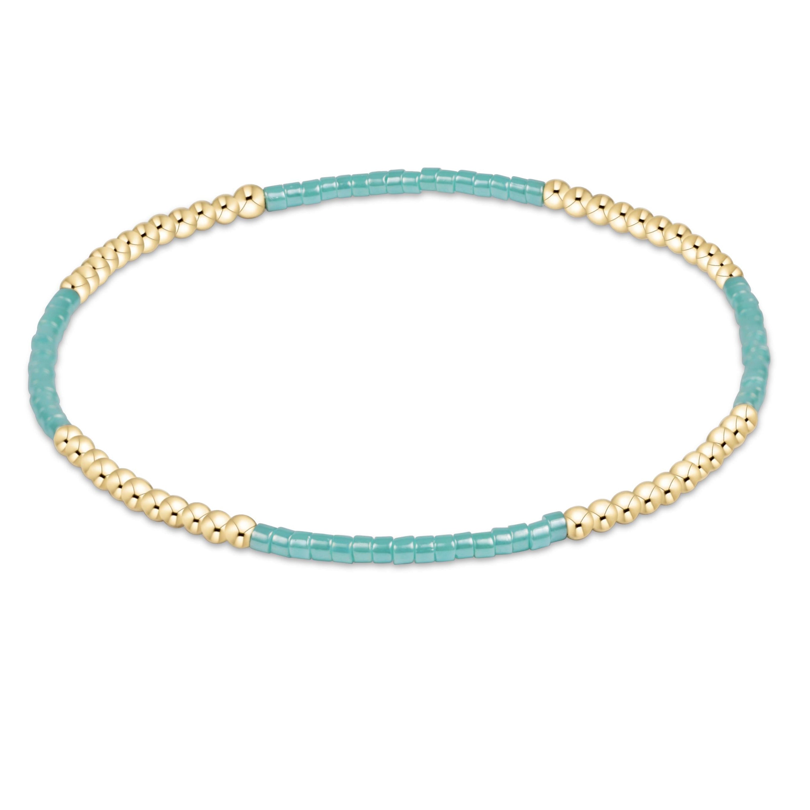 Beaded bracelet with gold and turquoise beads on a white background