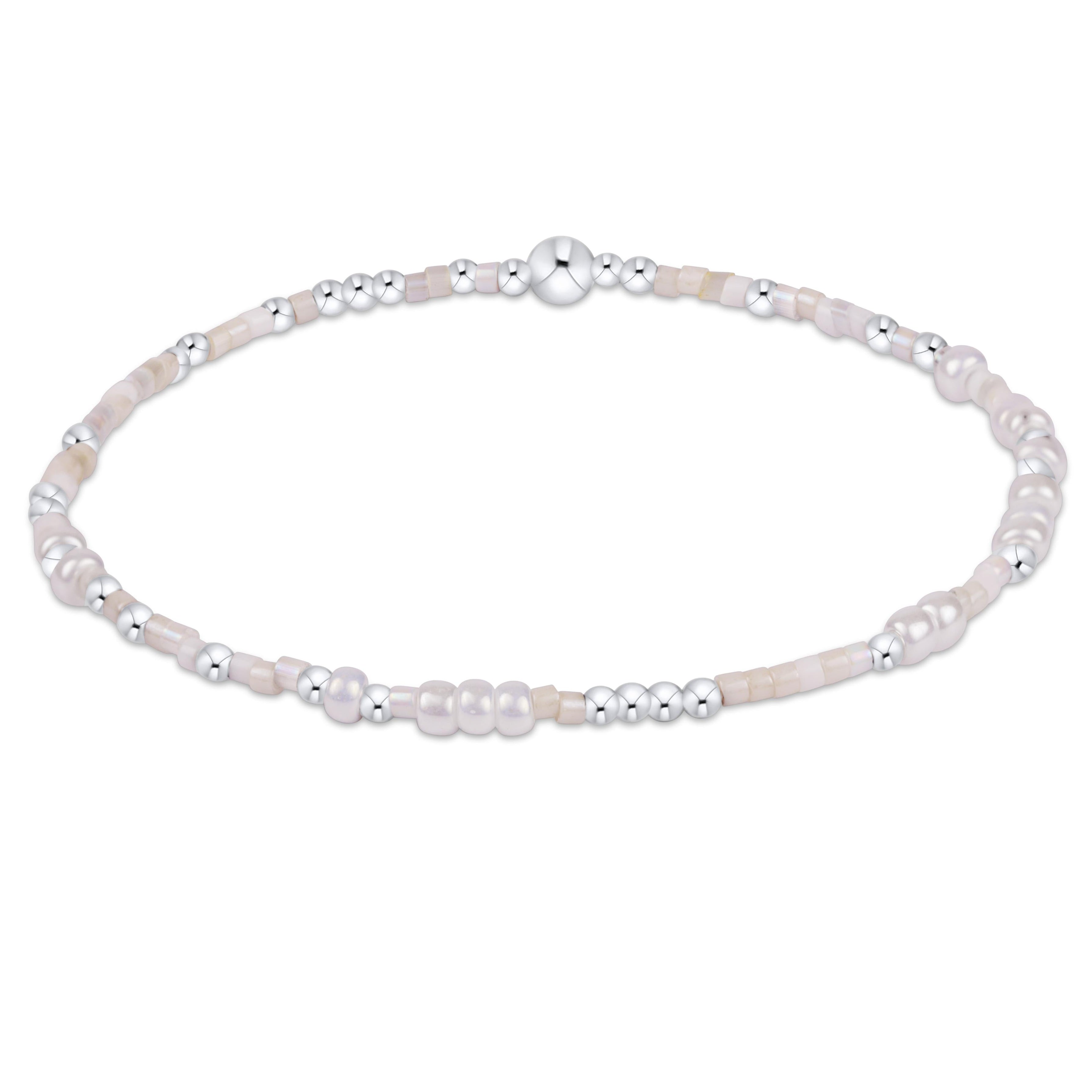 Pearl bracelet with silver beads on a white background