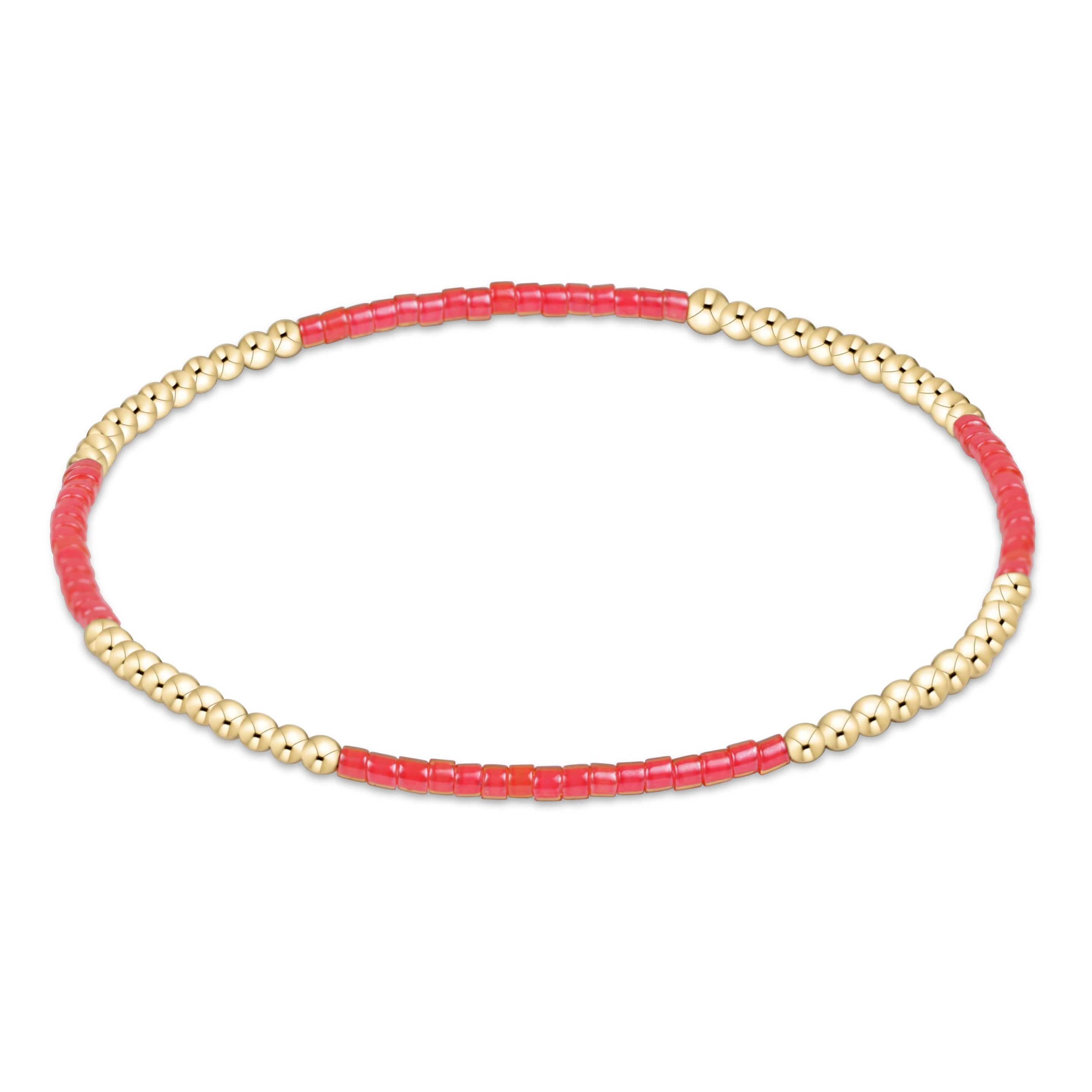 Bracelet with pink beads and gold accents on a white background