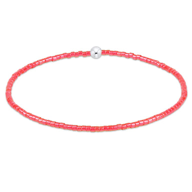 Necklace with pink beads and a silver clasp on a white background