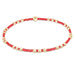 Bracelet with red and gold beads on a white background