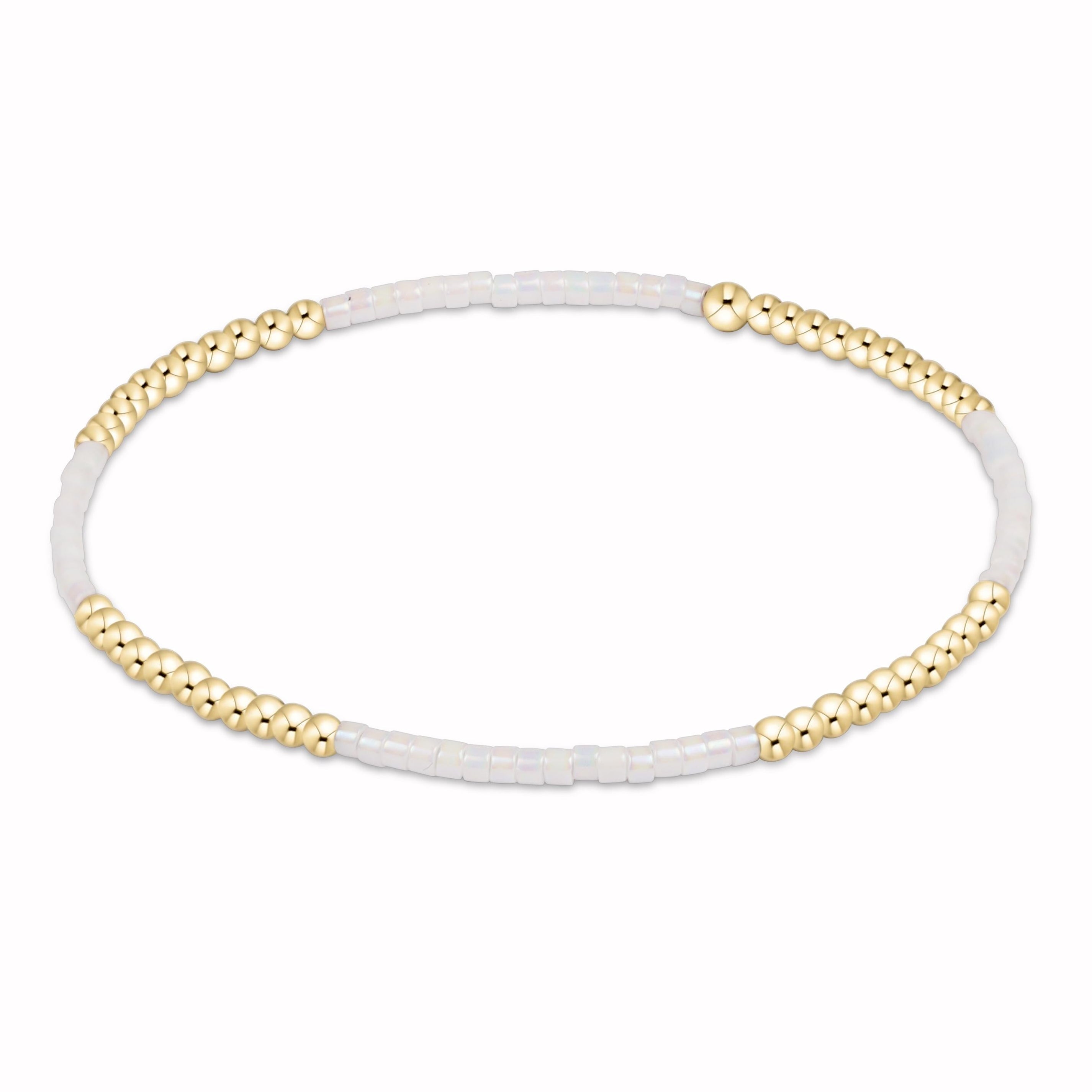 Bracelet with gold beads on a white background