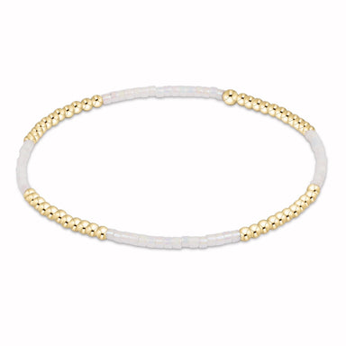 Bracelet with gold beads on a white background