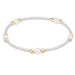 Bracelet with white beads and gold accents on a white background