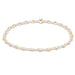 Beaded bracelet with gold and white beads on a white background