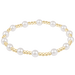 Pearl and gold beaded bracelet on a white background